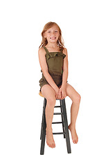 Image showing Girl sitting on high chair.