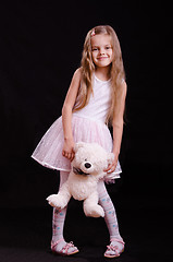 Image showing Happy girl playing with teddy bear