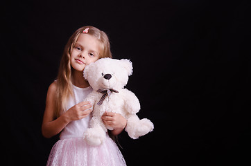 Image showing Portrait of happy girl with a soft bear