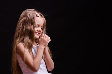 Image showing Happy girl thinks of a dream come true