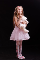 Image showing Happy girl standing with teddy bear