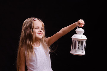 Image showing Five-year girl shines candlestick