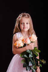 Image showing Sad five year old girl with a bouquet of flowers