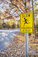 Image showing Yellow Slow Children at Play Road Sign and road