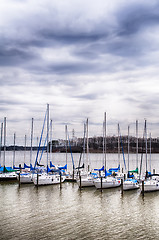 Image showing parked yachts in harbour with cloudy skies