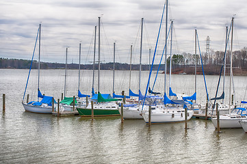 Image showing parked yachts in harbour with cloudy skies