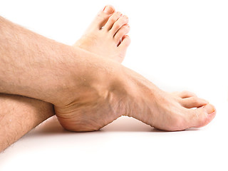 Image showing Hairy legs and feet of male person resting towards white backgro