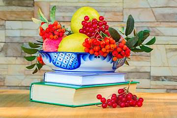 Image showing Still life: books and fruit and berries in a beautiful vase.