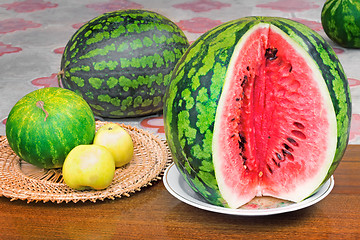 Image showing Ripe sliced watermelon and apples.