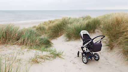 Image showing Baby stroller standing at a beach 