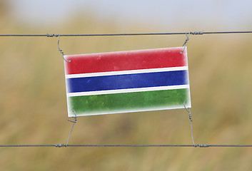 Image showing Border fence - Old plastic sign with a flag