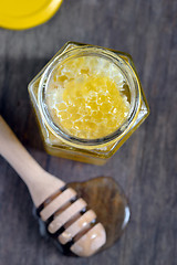 Image showing honeycomb and honey in glass jars