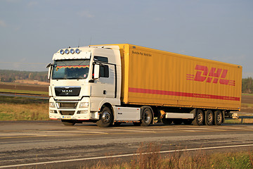 Image showing White MAN TGX 18.480 Truck Hauls DHL Trailer