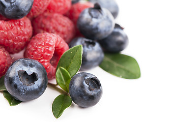 Image showing Many blueberries, raspberries. Isolated white