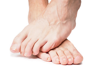 Image showing Male feet on over the other isolated towards white