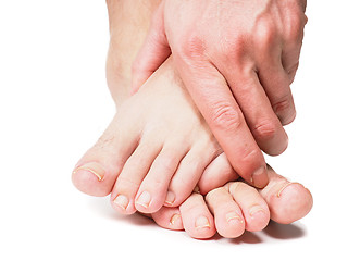 Image showing Male person holding onto feet isolated towards white