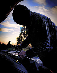 Image showing Hooligan breaking into car