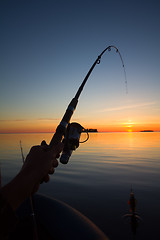 Image showing Sunset river perch fishing with the boat and a rod