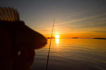 Image showing Sunset river perch fishing with the boat and a rod