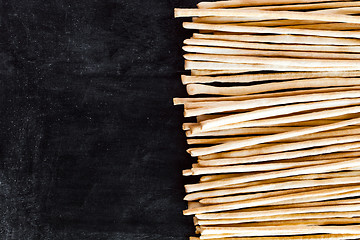 Image showing breadsticks grissini torinesi on blackboard