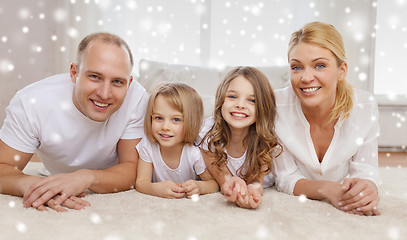 Image showing smiling parents and two little girls at home