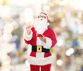 Image showing man in costume of santa claus with notepad