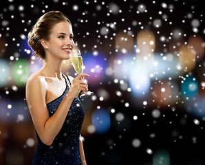 Image showing smiling woman holding glass of sparkling wine