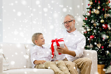 Image showing smiling grandfather and grandson at home