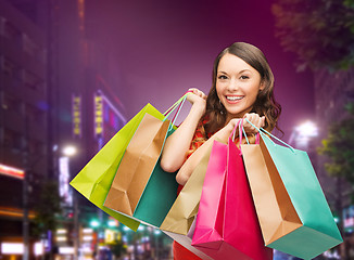 Image showing smiling young woman with shopping bags