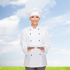 Image showing smiling female chef with tablet pc computer