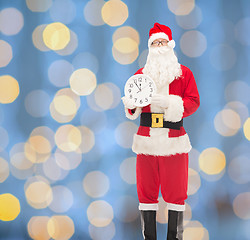 Image showing man in costume of santa claus with clock