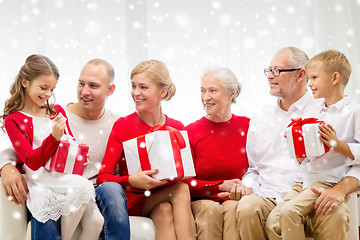 Image showing smiling family with gifts at home