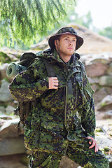 Image showing young soldier with backpack in forest