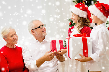 Image showing smiling family with gifts at home