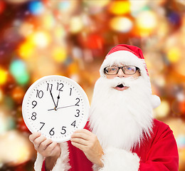 Image showing man in costume of santa claus with clock