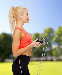 Image showing smiling sporty woman with skipping rope