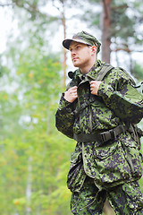 Image showing young soldier with backpack in forest