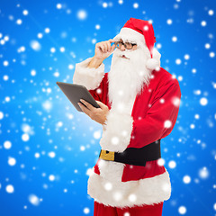 Image showing man in costume of santa claus with tablet pc