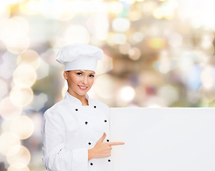 Image showing smiling female chef with white blank board