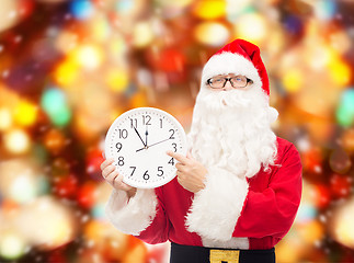 Image showing man in costume of santa claus with clock