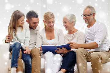 Image showing happy family with book or photo album at home