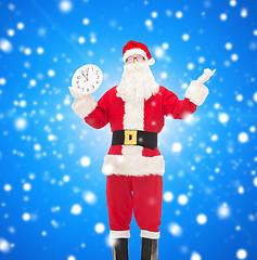 Image showing man in costume of santa claus with clock