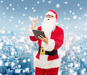 Image showing man in costume of santa claus with tablet pc