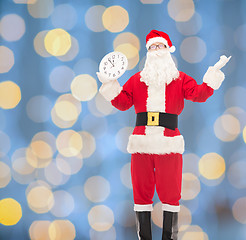 Image showing man in costume of santa claus with clock