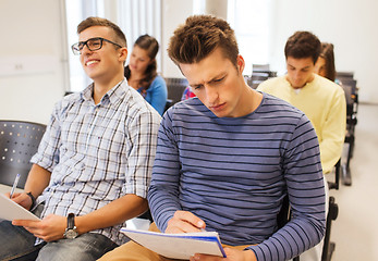 Image showing group of smiling students in lecture hall