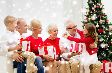 Image showing smiling family with gifts at home