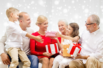 Image showing smiling family with gifts at home