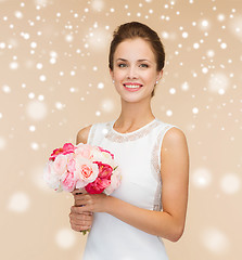 Image showing smiling woman in white dress with flowers