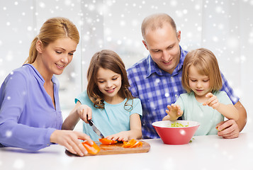 Image showing happy family with two kids making dinner at home