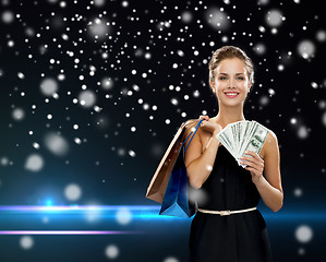 Image showing smiling woman in dress with shopping bags